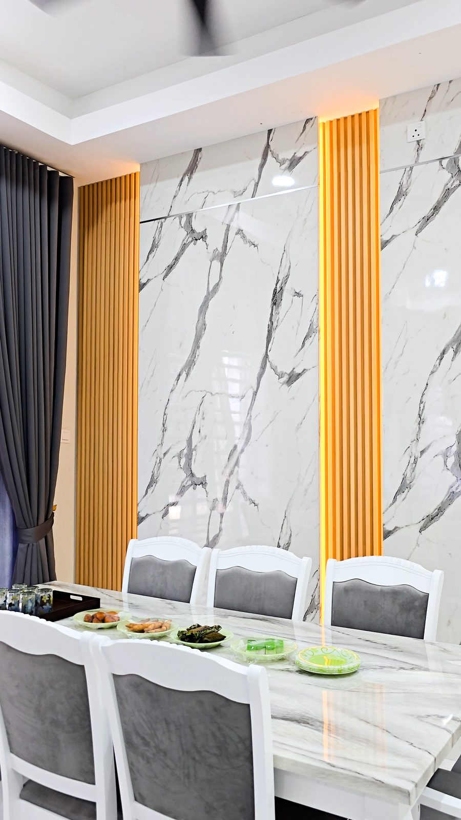 Dining area with marble and timber feature wall