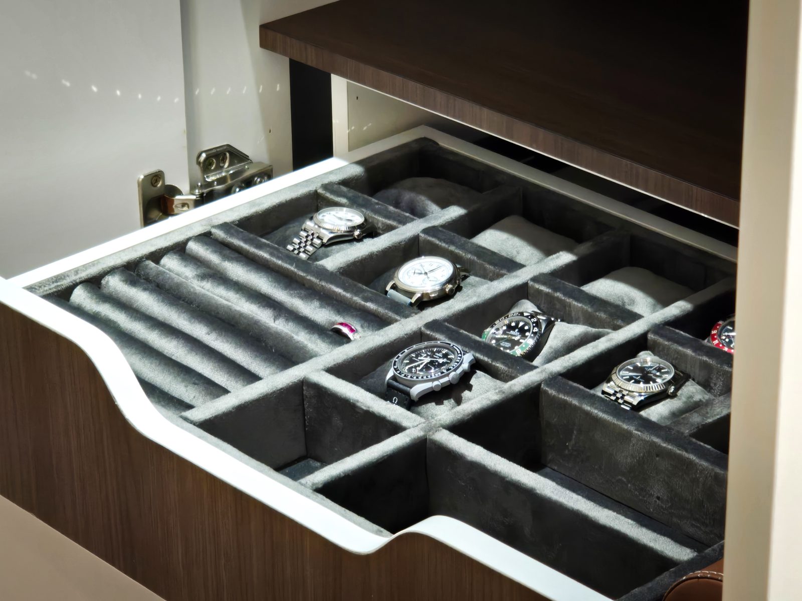 Velvet-lined watch drawer detail in a custom wardrobe