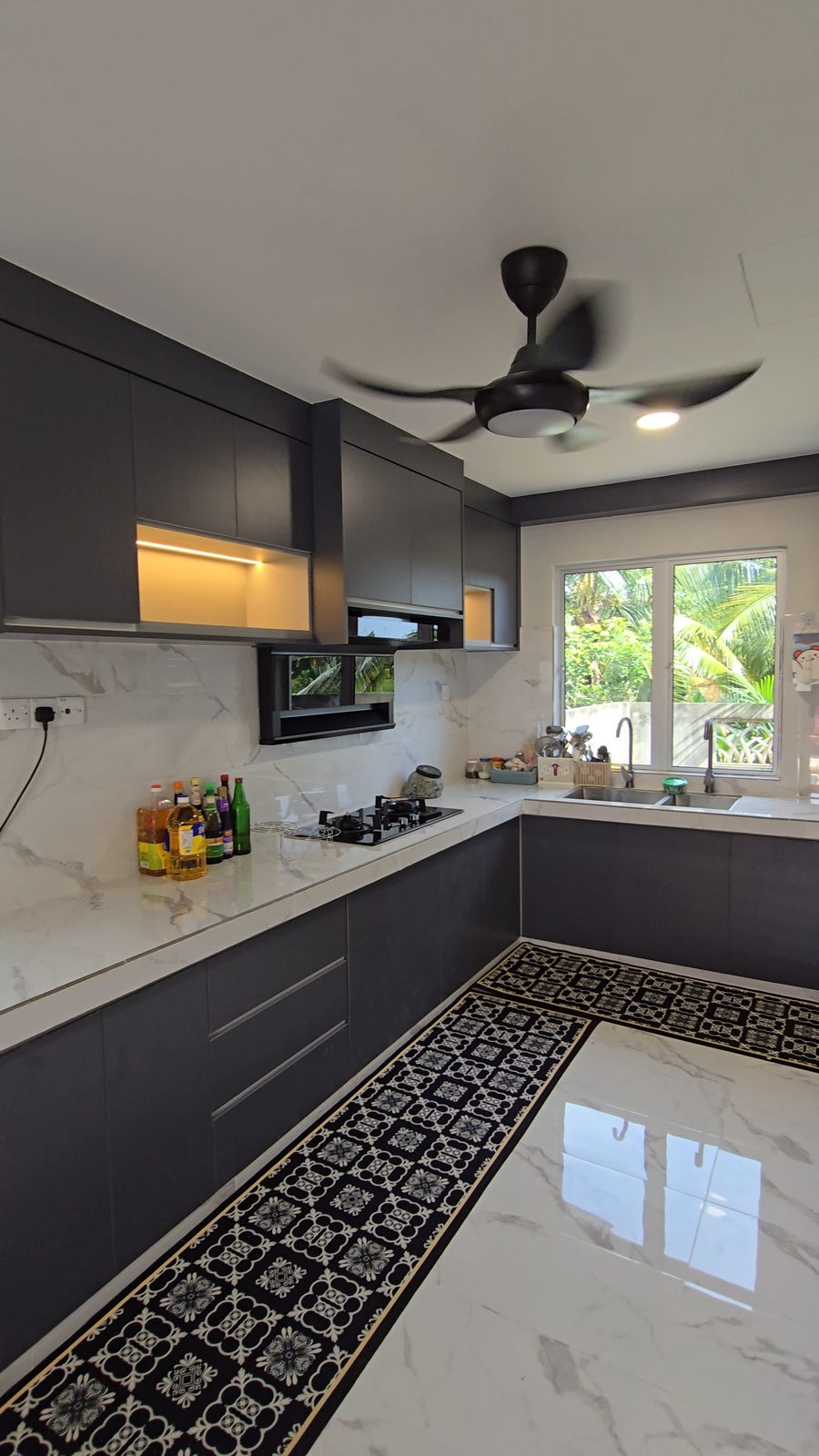 Charcoal wet kitchen with marble tops and patterned floor